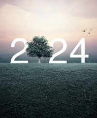2024 white letter with tree on green grass field over aerial view of cityscape at sunset, vintage...