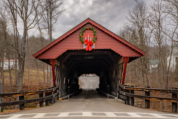 Fototapeta na wymiar Historic timber one lane covered bridge in the Town of Newfield, Tompkins County NY with holiday lights. 