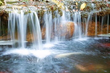 Large boulders are placed on the lower level of the waterfall.