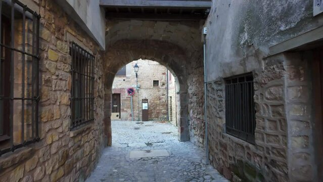 Picturesque alley with stone houses and cobblestone floors in the medieval town of Siguenza, Spain.