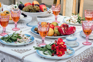 Beautiful still life with fruits, flowers and red wine.