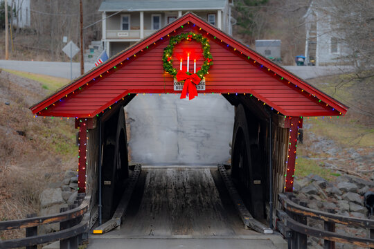 Historic timber one lane covered bridge in the Town of Newfield, Tompkins County NY with holiday lights.	