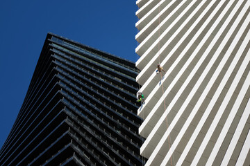 Close-up a cleaning company performs work on a skyscraper.