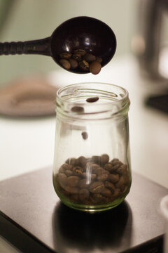 holding a tablespoon roasted coffee
