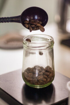 holding a tablespoon roasted coffee 