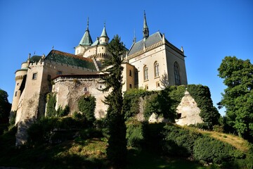 View from behind the trees of the old walls castle Bojnice Slovakia