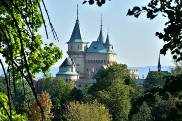 View from behind the trees of the old walls castle Bojnice Slovakia - 690893747