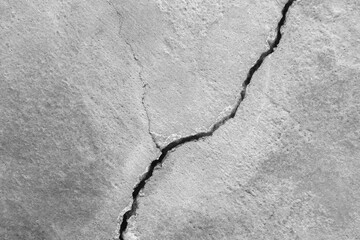 Big long curve ascending crack on old plastering wall. Copy space. Black and white photo. Selective...