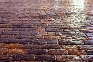 icy paving stones in the evening light - obrazy, fototapety, plakaty