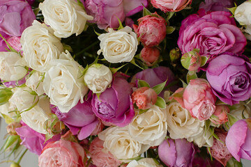Pink purple white roses background. Top view of a large beautiful bouquet in different poses. The concept of Valentine's day, wedding, birthday. Natural bright background. Mother's Day Greeting Card