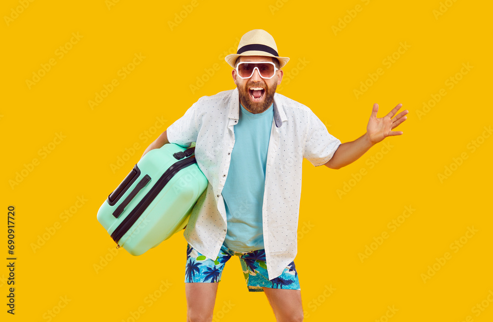 Wall mural happy male tourist with suitcase. joyful bearded man in summer clothes, cool sunglasses and fedora s