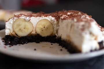 Classic banoffee pie a simple cookie crust is filled with thick caramel, slices of fresh banana and whipped cream on top. 