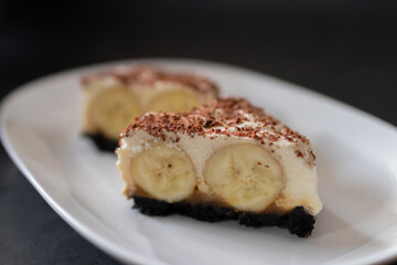Classic banoffee pie a simple cookie crust is filled with thick caramel, slices of fresh banana and whipped cream on top. 