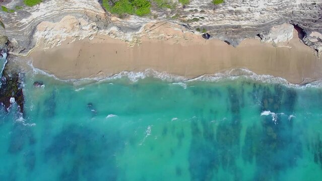 Top view of clear blue ocean water. Beautiful water texture. Azure Bay along the cliffs