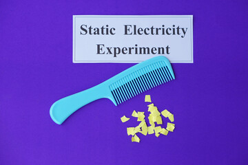Comb and small pieces of paper. Equipment, prepared to do experiment about static electricity. Blue...