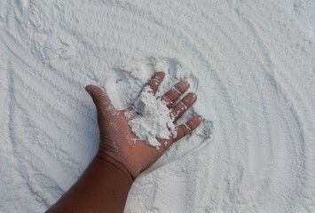 Snow-Covered Hand in a Blizzard. Frosty hand braving snowy blizzard with falling snowflakes.