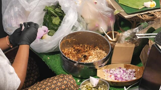 Making Miang Kham (traditional Southeast Asian herbal snack from Thailand and Laos), Traditional Thai snack. It&rsquo;s a snack containing different ingredients of herbs and vegetables. 