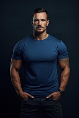 Fototapeta na wymiar Muscular male fashion model with a blue t-shirt.