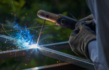 smoke art created by SMAW welding metal steel square tubes