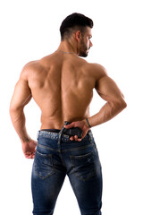 Fototapeta premium A shirtless muscular man with his back to the camera, holding a gun, isolated on white in studio shot