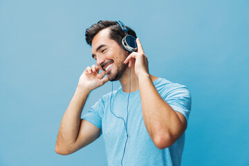 Man online background lifestyle studio portrait t-shirt space fun headphone sing blue happy copy music