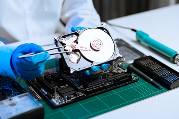 Obraz premium Electronics technician, electronic engineering electronic repair, electronics measuring and testing, repair and maintenance concepts.uses a voltage meter to check and upgrade in shop.