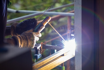 Spark made by Shielded metal arc welding on Galvanized metal square tubes