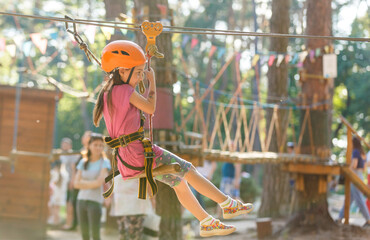 Smiling little girl on the playground, climbing rope net