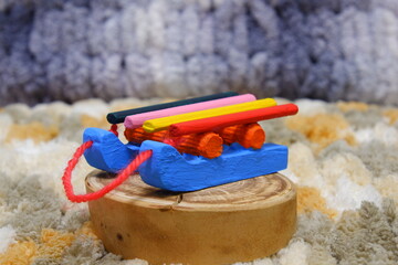 Christmas miniature sleigh, bright, painted with acrylic paints. The sleigh is made from wood with your own hands. Suitable as a background for a Christmas card.