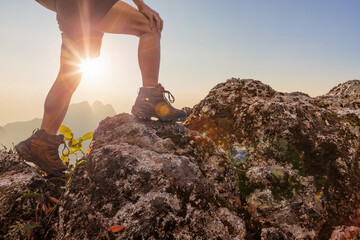 Hiker walking on top mountain sunset background. Hiker men's hiking living healthy active lifestyle.