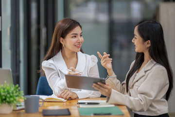 Two business worker consult and plan together. Brainstorm, share, and discuss business project ideas.