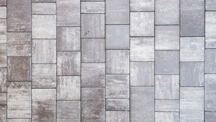  Gray cement bricks paving creating a textured surface road.