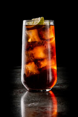 Fresh made coktail Cuba Libre with brown rum, cola and lemon