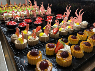 Rows of tiny desserts with caramel and custard - obrazy, fototapety, plakaty