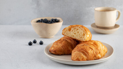Fresh croissants on a plate. French breakfast.