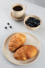 Fresh croissants on a plate. French breakfast.
