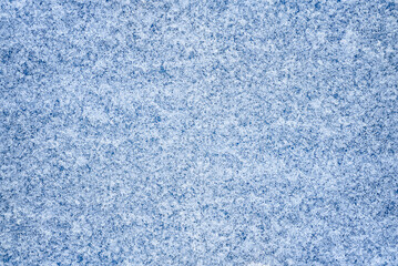 Winter abstract background. Snowflake pattern on a blue background. Macro texture. Natural background. View from above.

