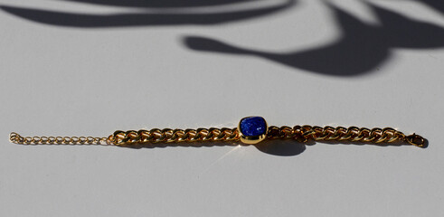 Bracelet with golden vintage chain and precious colored shiny zircon stones. Accessory with...