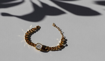 Bracelet with golden vintage chain and precious colored shiny zircon stones. Accessory with...