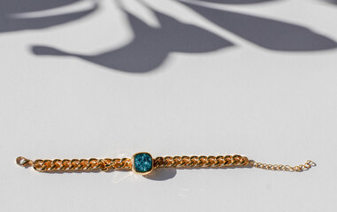 Bracelet with golden vintage chain and precious colored shiny zircon stones. Accessory with...