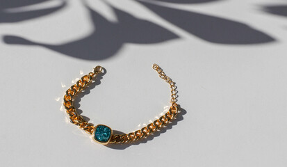 Bracelet with golden vintage chain and precious colored shiny zircon stones. Accessory with turquoise, white, purple, violet, lavender, pink and green stones. yellow ring chain jewelry. macro, photo. 