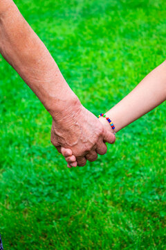 grandmother holds her granddaughter's hands. selective focus