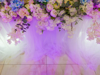 Flower decoration against the floor marble tiles with purple backlight