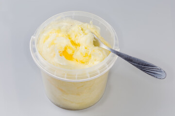 Cotton candy in open container with fork on gray background