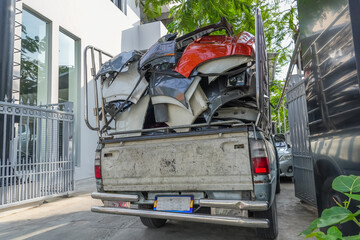 Scrap metal and car fenders in the back of a pickup truck.