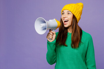 Young woman she wear green sweater yellow hat casual clothes hold in hand megaphone scream...