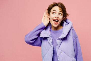 Young curious nosy woman she wear purple vest sweatshirt casual clothes try to hear you overhear listening intently isolated on plain pastel light pink background studio portrait. Lifestyle concept. - obrazy, fototapety, plakaty