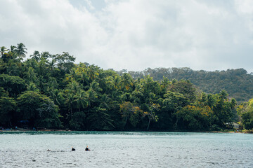 People snorkeling in a turquoise Caribbean sea