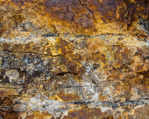 Colorful rock with yellow, red, orange shades coming from oxydation of the iron. Granite. Colca Canyon, Peru.