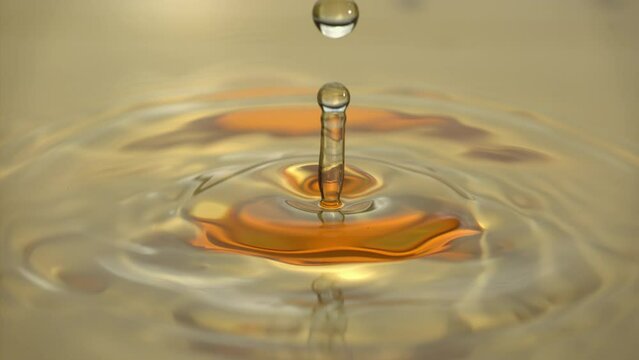 Cosmetics golden serum liquid. Falling drop macro abstract background. Cosmetic moisturizer essence gel. Collagen fluid bubble molecule. Yellow moisturizing cream oil. Beauty skin health care concept